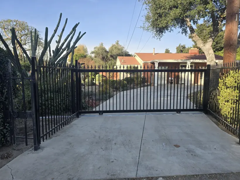 Ornamental wrought iron driveway gate at a Chino-area residential property by Apexguard Fence