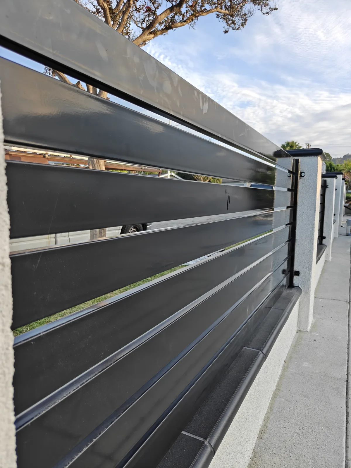 Close-up detail of black powder-coated horizontal fence slats with even spacing in La Puente, CA by Apexguard Fence