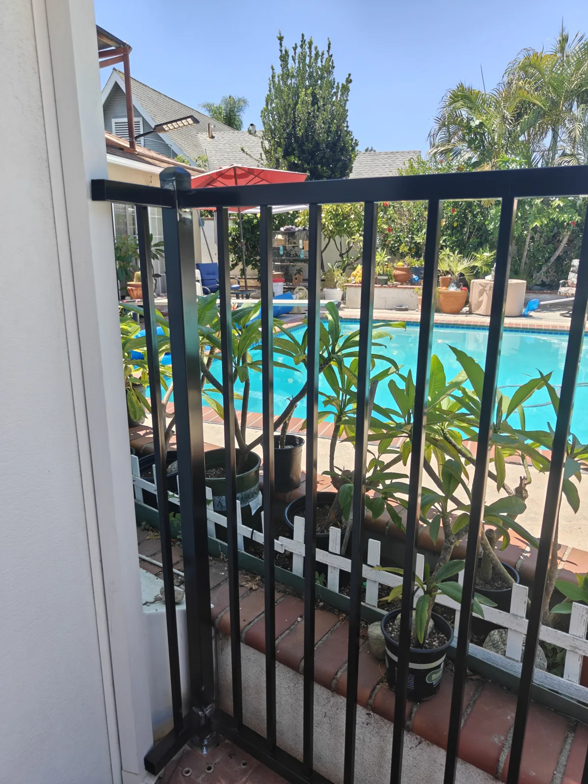 Vertical picket detail on a black iron pool fence in Ontario, CA by Apexguard Fence