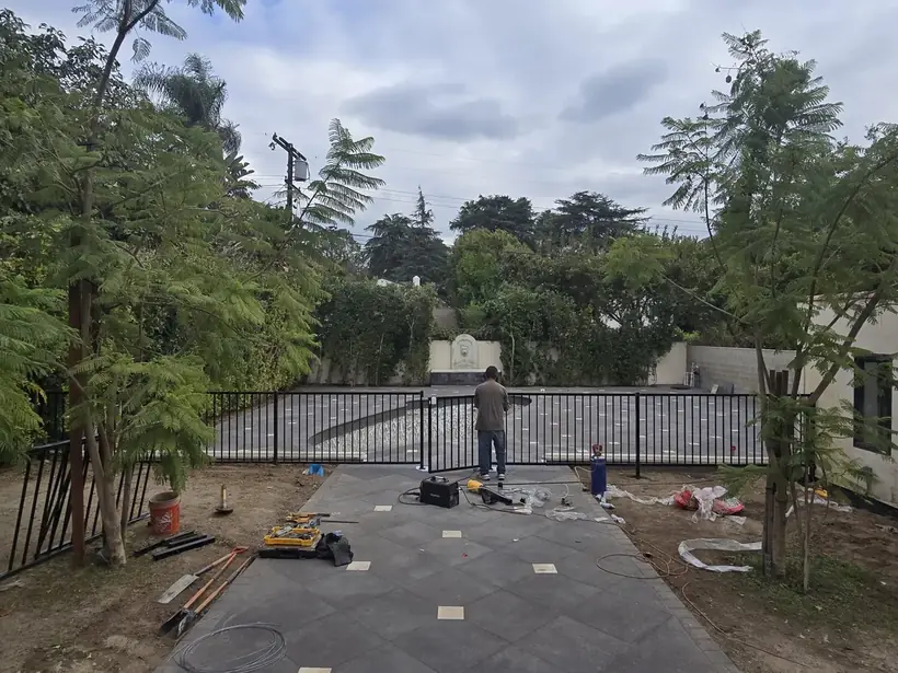 Black metal pool safety fence installed by Apexguard Fence
