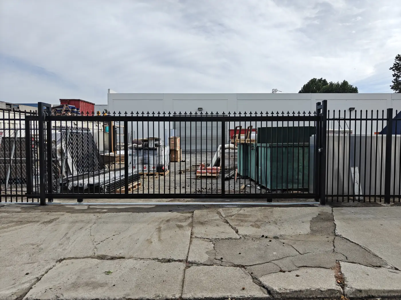 Completed 23 ft single sliding gate closed across the second commercial driveway opening in Whittier, CA