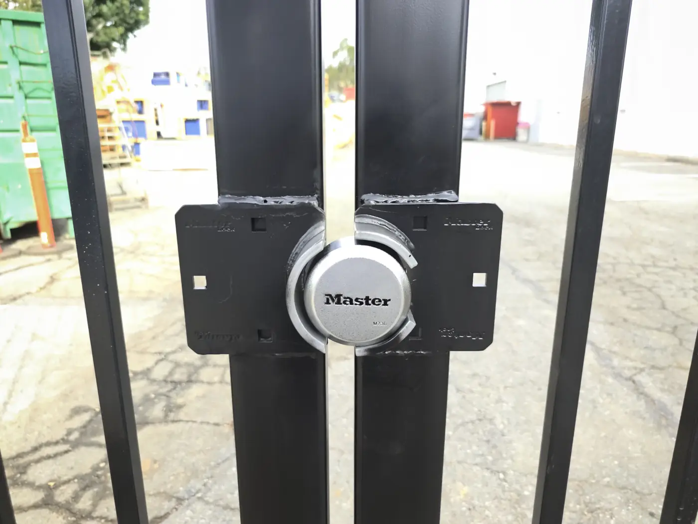 Protected lock box and padlock detail on a commercial steel sliding gate in Whittier, CA